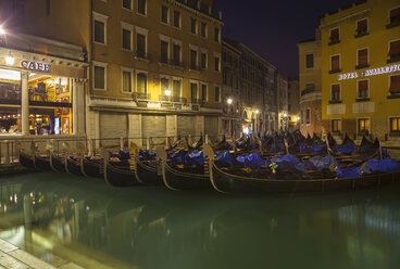 Italy, Venice, Gondalas on canal near St Mark's Square at night - HSIF000263