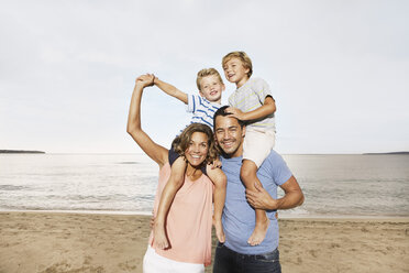 Spain, Portrait of family on beach at Palma de Mallorca, smiling - SKF001200