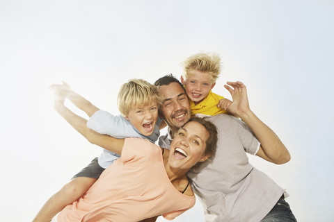 Spain, Family having fun on beach at Palma de Mallorca, smiling stock photo