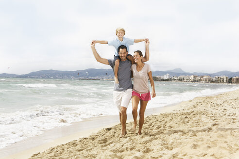 Spain, Family walking on beach at Palma de Mallorca - SKF001229