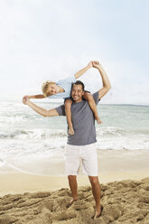 Spain, Father and son having fun on beach at Palma de Mallorca, smiling - SKF001231