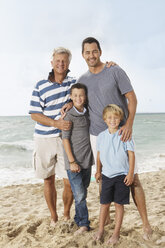 Spain, Portrait of family on beach at Palma de Mallorca, smiling - SKF001233