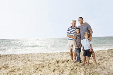 Spain, Portrait of family on beach at Palma de Mallorca, smiling - SKF001241