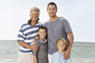 Spain, Portrait of family on beach at Palma de Mallorca, smiling - SKF001187