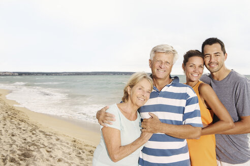 Spain, Family on beach at Palma de Mallorca, smiling - SKF001211