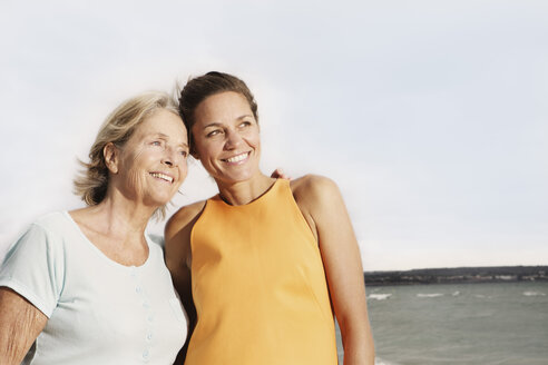 Spain, Women on beach at Palma de Mallorca, smiling - SKF001214