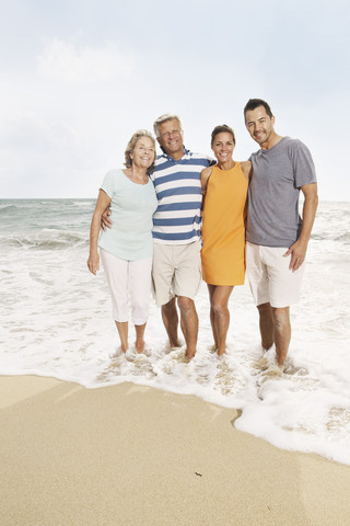 Spain, Portrait of family on beach at Palma de Mallorca, smiling stock photo