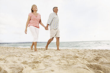 Spain, Senior couple walking on beach at Palma de Mallorca - SKF001179