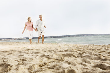 Spain, Senior couple walking on beach at Palma de Mallorca - SKF001180