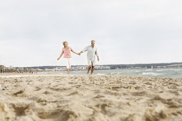 Spain, Senior couple walking on beach at Palma de Mallorca - SKF001181