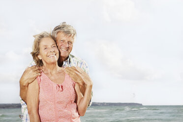 Spain, Senior couple embracing on beach at Palma de Mallorca - SKF001184