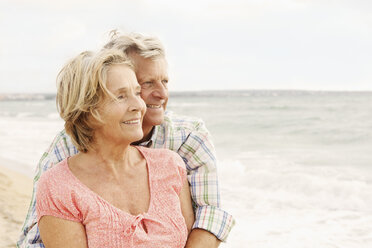 Spain, Senior couple embracing on beach at Palma de Mallorca - SKF001185