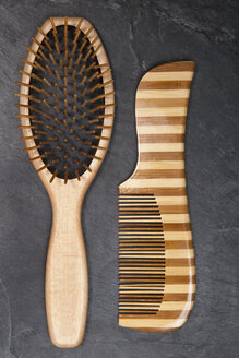 Hair brush and comb on slate board, close up - TDF000043