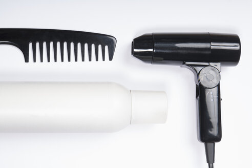 Hair dryer, comb and spray on white background, close up - TDF000047