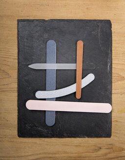 Nail file, emery boards on slate board, close up - TDF000026