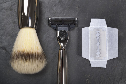 Shaving brush, razor and razor blade on slate board, close up - TDF000024