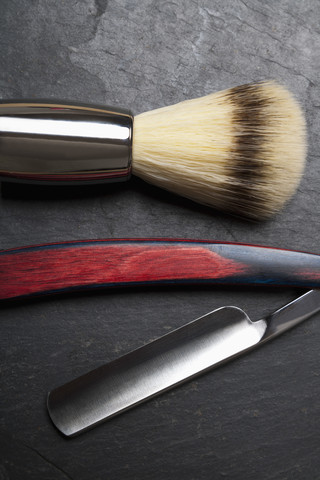 Shaving brush and razor on slate board, close up stock photo