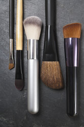 Make up brushes on slate board, close up - TDF000034