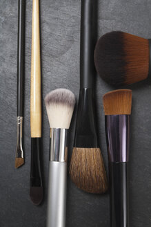 Make up brushes on slate board, close up - TDF000007