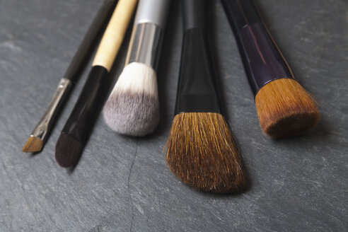 Make up brushes on slate board, close up - TDF000006