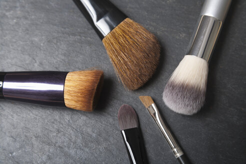 Make up brushes on slate board, close up - TDF000005