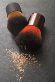 Make up brushes and make up powder on slate board, close up - TDF000004