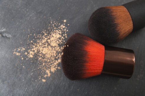 Make up brushes and make up powder on slate board, close up - TDF000003