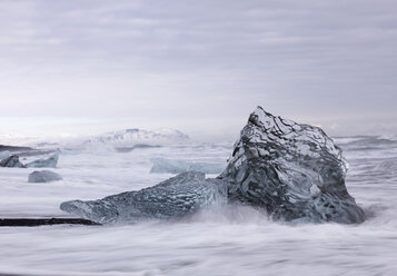 Iceland, View of isolated Icebergs on Black Lava Beach - BSCF000253