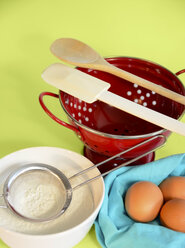 Baking utensils, brown eggs, flour on plain background - ONF000136