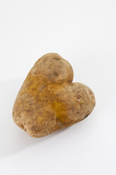 Potato in heart shape on white background, close up - CSF018617