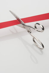 Scissors cutting inauguration red ribbon, close-up - CRF002367