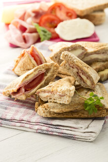 Schinken-Käse-Sandwich mit Tomaten auf Serviette - MAEF006436