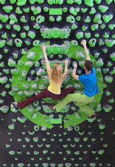 Germany, Bavaria, Munich, Young man helping woman to climb - HSIYF000196