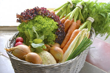 Germany, Carrots, asparagus, celery, onions, garden radish, chives in basket - ONF000152