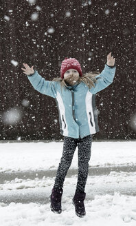 Austria, Girl jumping in snow - CWF000033