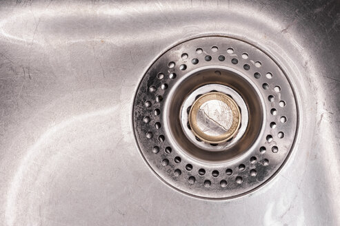 Euro coin in kitchen sink, close up - KJF000216