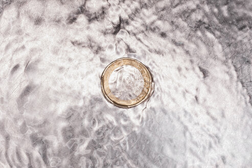 Euro coin in kitchen sink with flowing water, close up - KJF000219