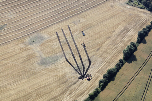 Germany, View of harvester on wheat field at Hartenholm - FB000009