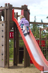 Germany, Girl climbing on slide - JFEF000083