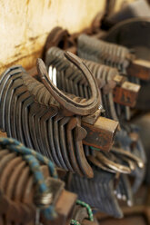 Germany, Horseshoe stacked in workers garage - TK000116