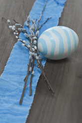 Easter eggs with willow twigs on cloth on wood - AS004913
