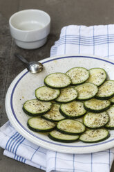 Plate of sliced marinated courgette, close up - EVG000090