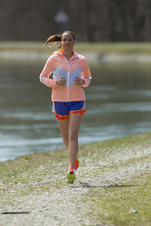 Gremany, Bavaria, Munich, Mid adult woman running - FF001342