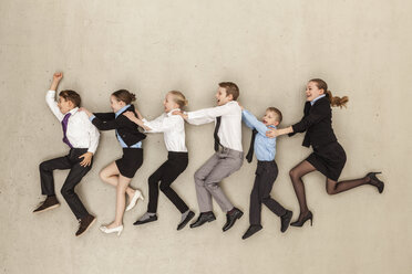 Business kids running against beige background - BAEF000601