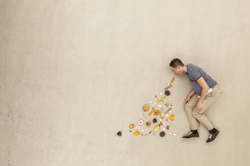 Man with food against beige background - BAEF000632