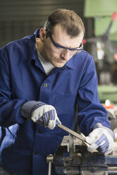 Germany, Kaufbeuren, Man working in manufacturing industry - CA000003