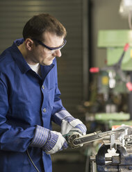 Germany, Kaufbeuren, Man working in manufacturing industry - CA000002