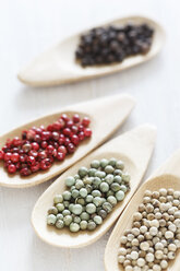 Variety of peppercorns on wooden spoon, close up - EVGF000117