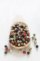 Variety of peppercorns on wooden spoon, close up - EVGF000122