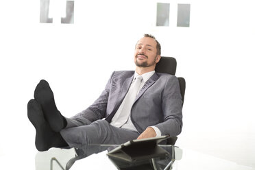 Germany, Portrait of businessman sitting relaxed - MAEF006611